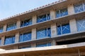 Unfinished modern building under construction with big windows