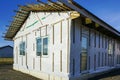 Unfinished modern one-story wood-frame residential house before facade finishing