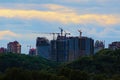 Unfinished multi-story apartment buildings. Construction site with modern luxury skyscrapers and tower-cranes Royalty Free Stock Photo