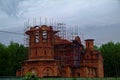 The unfinished Orthodox Church among the trees