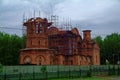 The unfinished Orthodox Church among the trees