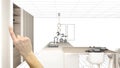 Unfinished project, under construction draft, concept interior design sketch, hand pointing real modern white kitchen with Royalty Free Stock Photo