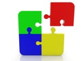 An unfinished puzzle of four colored pieces Royalty Free Stock Photo