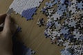 Unfinished puzzle over a wooden table Royalty Free Stock Photo