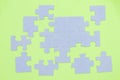 Unfinished puzzle pieces on green background. Top view Royalty Free Stock Photo