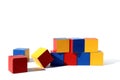 Children`s toy bright cubes lie scattered on a white background Royalty Free Stock Photo