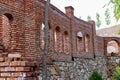 Unfinished red brick construction, old and textured stone. Large oval openings for the Windows, Royalty Free Stock Photo