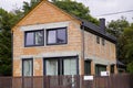 Unfinished red brick cottage with panoramic plastic Windows and an iron fence. construction, arrangement of the site near the Royalty Free Stock Photo