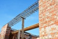 Unfinished Red Brick House Wall Under Construction without Roofing. Lintel Construction. Rebar steel bars on home construction, Royalty Free Stock Photo