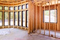 An unfinished residential home under construction with wood framing a beam supporting it