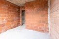 Unfinished room interior of building under construction. Brick red walls. New home Royalty Free Stock Photo