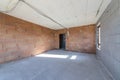 Unfinished room interior of building under construction. Brick red walls. New home Royalty Free Stock Photo