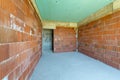 Unfinished room interior of building under construction. Brick red walls. New home Royalty Free Stock Photo