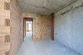 Unfinished room interior of building under construction. Brick red walls. New home Royalty Free Stock Photo