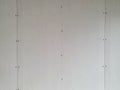 Unfinished sheetrock wall at construction site Royalty Free Stock Photo