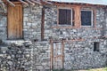 Unfinished stone house with wooden door and windows Royalty Free Stock Photo
