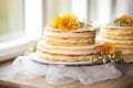 unfinished three-tiered wedding cake on a stand