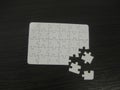 Unfinished white jigsaw puzzle pieces on black background Royalty Free Stock Photo