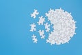 Unfinished white jigsaw puzzle pieces on blue background, Copy space