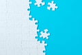 Jigsaw puzzle pieces on blue background