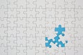 Unfinished white jigsaw puzzle pieces on blue background, The last piece of jigsaw puzzle, Copy space Royalty Free Stock Photo