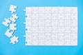 Unfinished white jigsaw puzzle pieces on blue background, The last piece of jigsaw puzzle, Copy space Royalty Free Stock Photo
