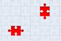 Unfinished white jigsaw puzzle pieces on red background. Top view Royalty Free Stock Photo