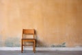 unfinished wooden chair against wall