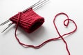 Unfinished wool and knitting needle design. Red thread and tangle. Handmade concept. Craft banner. Love, romantic, valentines day Royalty Free Stock Photo