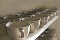 Unfired Pottery Cups in a Row