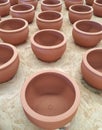 Unfished clay pots wait for burning process in pottery factory. Royalty Free Stock Photo