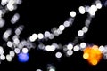 Unfocused abstract colourful bokeh with red, green, orange and blue lamp on black background. defocused and blurred many round Royalty Free Stock Photo