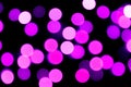 Unfocused abstract purple bokeh on black background. defocused and blurred many round light Royalty Free Stock Photo