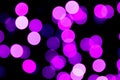 Unfocused abstract purple bokeh on black background. defocused and blurred many round light Royalty Free Stock Photo