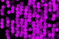 Unfocused abstract purple bokeh on black background. defocused and blurred many round light Royalty Free Stock Photo