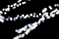 Unfocused abstract white bokeh on black background. defocused and blurred many round light Royalty Free Stock Photo