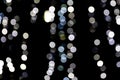Unfocused abstract white bokeh on black background. defocused and blurred many round light Royalty Free Stock Photo