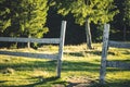 Unfocused artistic outdoor rural photography of wooden fence highland nature space with green and yellow bokeh foliage trees Royalty Free Stock Photo