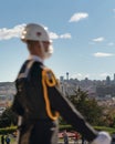 Unfocused blurred soldier with medical face mask stands guard at the mausoleum and panoramic view of Ankara in the background