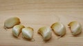 Garlic cloves on rustic in wooden table. Fresh peeled garlics and bulbs.