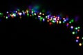 Unfocused color lamps garland home decoration on Christmas holidays, picture with black background