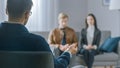 Unfocused Couple on Counseling Session with Psychotherapist. Focus on Back of Therapist Taking Notes Royalty Free Stock Photo