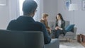 Unfocused Couple on Counseling Session with Psychotherapist. Focus on Back of Therapist Taking Notes Royalty Free Stock Photo