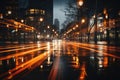 An unfocused image of an urban road at nighttime, filled with moving cars and a clock-bearing structure on the Royalty Free Stock Photo