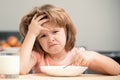 Unfocused little boy having soup for lunch. Unhappy Caucasian child sit at table at home kitchen have no appetite. Upset Royalty Free Stock Photo