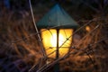 Unfocused outdoor lantern warm yellow illumination light in garden twilight lighting concept of autumn season