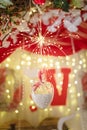 Unfocused shot of 14 February Valentines Day background. Shiny sparkling garland lights, flowers, hearts and bokeh.