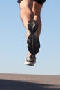 Unfocused sportsman legs running on the asphalt