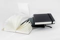 Unfold small notebooks lie on top of each other. Fan open notepad with blank light beige pages. White back. Sketchbooks
