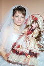 Unfortunate bride holding a beautiful doll